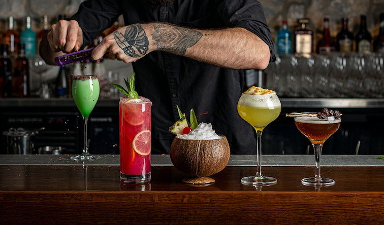 An image of a mixologist making a cocktail