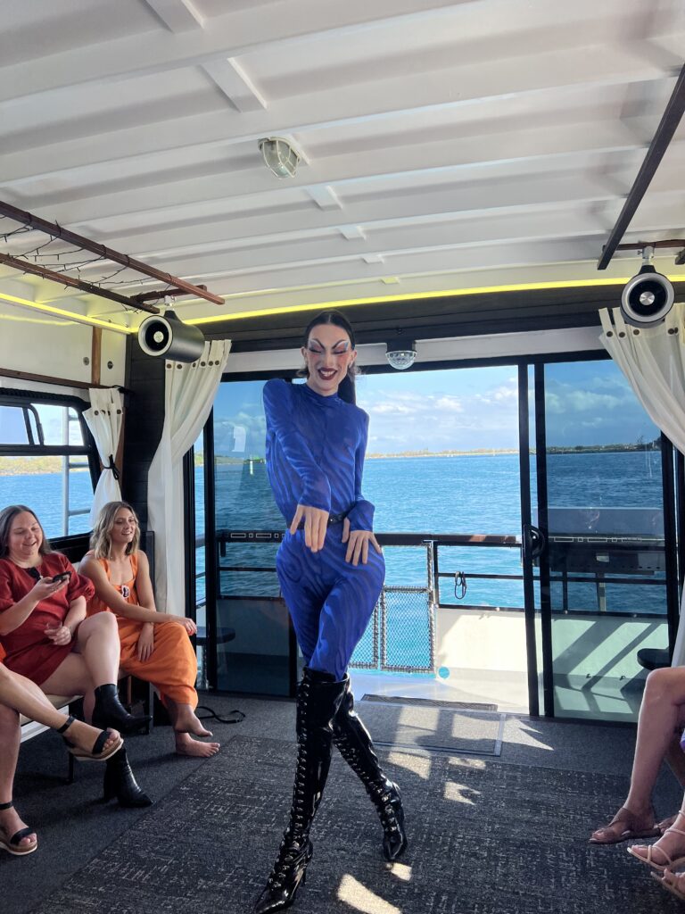 Drag queen doing dance on a boat