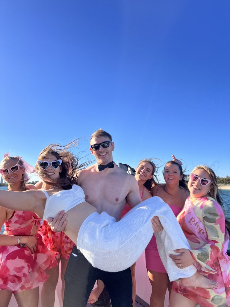 male host holding bride in his arms