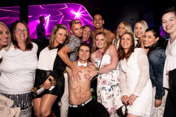 An image of a Male stripper with some Hens Party ladies