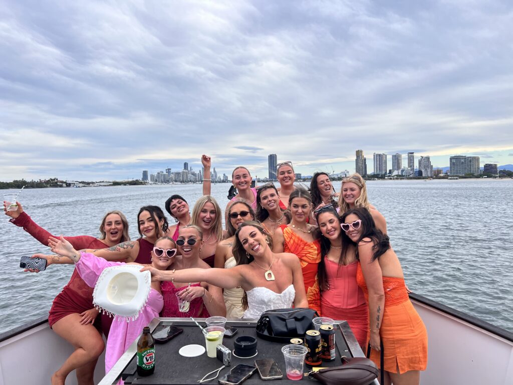 group of girls posing on the bow of a boat