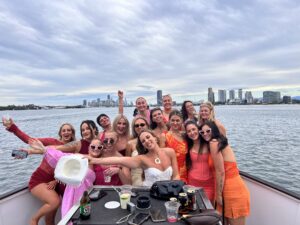 group of girls posing on the bow of a boat
